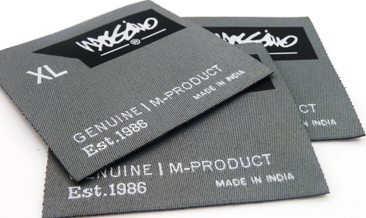 label, clothing label, woven label, tag, gray clothes, clothing label, clothing label, woven label, woven label, woven label, woven label, woven label. Pre-release clothing labels and certifications checklist